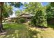 Well-manicured front lawn with mature landscaping and an established evergreen bush near the home at 2934 S Columbine St, Denver, CO 80210