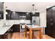 Well-lit kitchen boasting stainless steel appliances, dark cabinets, and a functional island at 2934 S Columbine St, Denver, CO 80210