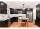 Modern kitchen with stainless steel appliances, kitchen island, and stylish pendant lighting at 2934 S Columbine St, Denver, CO 80210