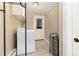 Laundry room with washer, utility sink, storage shelf, and access to outside at 2934 S Columbine St, Denver, CO 80210