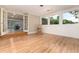 Bright room featuring hardwood floors, with abundant natural light from large windows and entry to another living space at 2934 S Columbine St, Denver, CO 80210