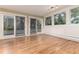 Bright room featuring hardwood floors, sliding glass doors and windows, offering abundant natural light and outdoor views at 2934 S Columbine St, Denver, CO 80210