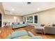 Open living room featuring beautiful hardwood floors, large windows, and comfortable stylish seating at 2934 S Columbine St, Denver, CO 80210