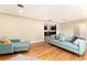 Spacious living room with hardwood floors, large window, and stylish furniture with a glimpse into the kitchen at 2934 S Columbine St, Denver, CO 80210