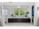 Bright bathroom featuring a soaking tub with tiled surround and large windows overlooking greenery at 1480 Sterling Hill Ct, Castle Rock, CO 80104