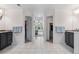 Large bathroom featuring double vanities, neutral tiling, separate toilet closets, and hall to bedroom at 1480 Sterling Hill Ct, Castle Rock, CO 80104