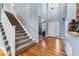 Two-story entryway with hardwood floors and staircase at 1480 Sterling Hill Ct, Castle Rock, CO 80104