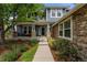 Inviting front porch with stone pillars, lovely landscaping, and a welcoming entryway at 1480 Sterling Hill Ct, Castle Rock, CO 80104