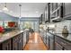 Modern kitchen boasts expansive granite countertops and dark wood cabinetry at 1480 Sterling Hill Ct, Castle Rock, CO 80104