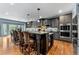 Eat-in kitchen features dark cabinetry, stainless steel appliances, and granite countertops at 1480 Sterling Hill Ct, Castle Rock, CO 80104