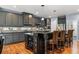 Updated kitchen with dark cabinets, granite island, and wine storage at 1480 Sterling Hill Ct, Castle Rock, CO 80104