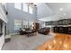 Spacious living room with high ceilings, large windows, and a cozy fireplace at 1480 Sterling Hill Ct, Castle Rock, CO 80104