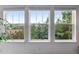 Three windows showcase a scenic wooded view at 1480 Sterling Hill Ct, Castle Rock, CO 80104