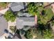 Aerial view of a home with a gray roof, a lush green yard, and a wood deck at 2043 Fendlebrush St, Highlands Ranch, CO 80129
