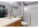 Bathroom featuring a vanity with a sink, toilet, glass shower, and neutral tile at 2043 Fendlebrush St, Highlands Ranch, CO 80129