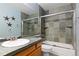 Bathroom featuring green tile surround and large mirror at 2043 Fendlebrush St, Highlands Ranch, CO 80129