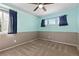 Bedroom featuring two windows with brown carpet and blue walls at 2043 Fendlebrush St, Highlands Ranch, CO 80129