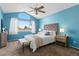Cozy bedroom with a large window, ceiling fan, stylish furnishings, and a vaulted ceiling at 2043 Fendlebrush St, Highlands Ranch, CO 80129