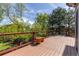 A wooden deck overlooking a green space and residential neighborhood at 2043 Fendlebrush St, Highlands Ranch, CO 80129