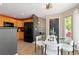 Bright dining area near kitchen features modern table with seating for six and wood floors at 2043 Fendlebrush St, Highlands Ranch, CO 80129