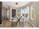 Bright dining area featuring a glass table, stylish chairs, and sliding glass doors leading to a deck at 2043 Fendlebrush St, Highlands Ranch, CO 80129