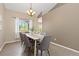 Formal dining room with modern chandelier, neutral walls and wood flooring at 2043 Fendlebrush St, Highlands Ranch, CO 80129