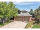 Inviting two-story home with mature trees, a two-car garage, and a basketball hoop at 2043 Fendlebrush St, Highlands Ranch, CO 80129