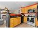 Modern kitchen featuring stainless steel appliances, granite counters and adjacent living room at 2043 Fendlebrush St, Highlands Ranch, CO 80129