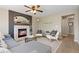 Cozy living room featuring a brick fireplace and comfortable seating arrangement at 2043 Fendlebrush St, Highlands Ranch, CO 80129