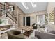Bright living room featuring skylights, vaulted ceilings, and modern furnishings at 2043 Fendlebrush St, Highlands Ranch, CO 80129
