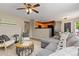 Open living space flowing into kitchen and dining area with neutral decor and wood floors at 2043 Fendlebrush St, Highlands Ranch, CO 80129
