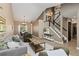 Open-concept living area with stairs, neutral paint, modern decor, and wood floors at 2043 Fendlebrush St, Highlands Ranch, CO 80129
