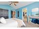Blue bedroom with furnishings, including an entry to an ensuite bathroom and staircase beyond the room at 2043 Fendlebrush St, Highlands Ranch, CO 80129
