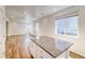 Open concept living room features wood floors, white walls, recessed lights, and an island with granite countertops at 23950 E 41St Ave, Aurora, CO 80019