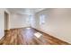 An empty living room with wood floors and lots of natural light from the windows at 23950 E 41St Ave, Aurora, CO 80019