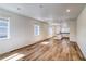 Spacious living room with wood floors, white walls, and natural light from the many windows at 23950 E 41St Ave, Aurora, CO 80019