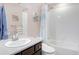 Bathroom featuring a well-lit vanity, a shower-tub combo, and colorful decor accents at 3385 Birch Rd, Longmont, CO 80504