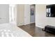 Bright bedroom boasts hardwood floors with a glimpse into the connected bathroom with a soaking tub at 3385 Birch Rd, Longmont, CO 80504