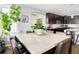 Elegant dining room with a marble-topped table, hardwood floors, and adjacent kitchen at 3385 Birch Rd, Longmont, CO 80504