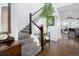 Bright foyer with a staircase and a view into the living room with modern furniture at 3385 Birch Rd, Longmont, CO 80504