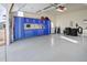 Well-organized garage space with full wall-mounted cabinets, workspace, and epoxy flooring at 3385 Birch Rd, Longmont, CO 80504