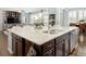 Gourmet kitchen island featuring granite countertops, dark wood cabinets, and stainless steel appliances at 3385 Birch Rd, Longmont, CO 80504