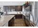 Modern kitchen with dark cabinetry, stainless steel appliances, and granite countertops at 3385 Birch Rd, Longmont, CO 80504
