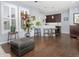 Open concept living room with hardwood floors and bar stool seating at a kitchen island at 3385 Birch Rd, Longmont, CO 80504