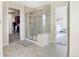 Bright bathroom featuring a glass-enclosed shower, a walk-in closet, and access to the bedroom at 3385 Birch Rd, Longmont, CO 80504