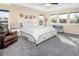 Comfortable main bedroom with a ceiling fan, many windows for natural light, and an upholstered bed with storage at 3385 Birch Rd, Longmont, CO 80504