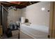 Basement bathroom featuring a shower-tub combo and tiled walls at 8659 E Kenyon Ave, Denver, CO 80237