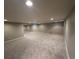 Large open basement featuring neutral-colored walls and cozy carpeting, perfect for customization at 8659 E Kenyon Ave, Denver, CO 80237