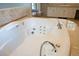 A close up of a bright and spacious hot tub that has tile flooring and columns at 8659 E Kenyon Ave, Denver, CO 80237