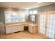 Bathroom with tile flooring, and white cabinetry below a set of windows at 8659 E Kenyon Ave, Denver, CO 80237